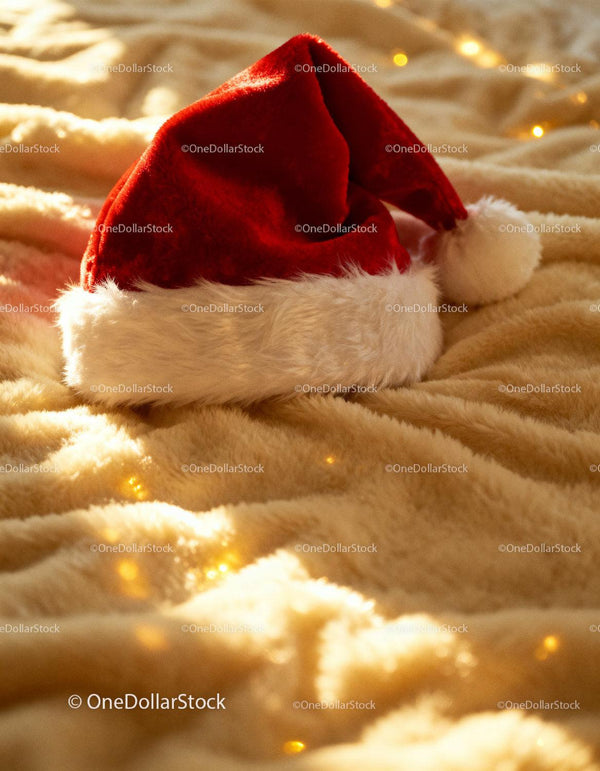 Cozy Santa Hat Resting on Soft Warm Blanket