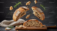 Rustic sourdough bread breaking apart with fresh rosemary