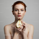 Elegant Woman with Fresh Pear in Minimalist Setting