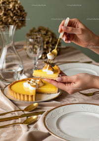 Lemon Tart Slice with Cream Topping on Elegant Dining Table