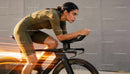 Focused Female Cyclist in Aerodynamic Racing Position
