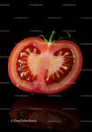 Fresh ripe tomato half with visible seeds and juice