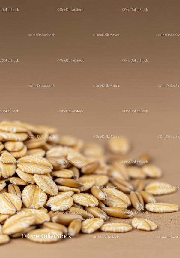 Close up of natural oat grains and flakes scattered
