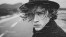 Black and White Portrait of Young Man with Wet Hair and Intense Gaze