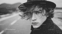 Black and White Portrait of Young Man with Wet Hair and Intense Gaze