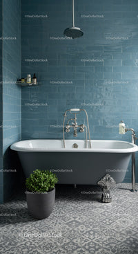 Modern clawfoot bathtub in stylish blue tiled bathroom