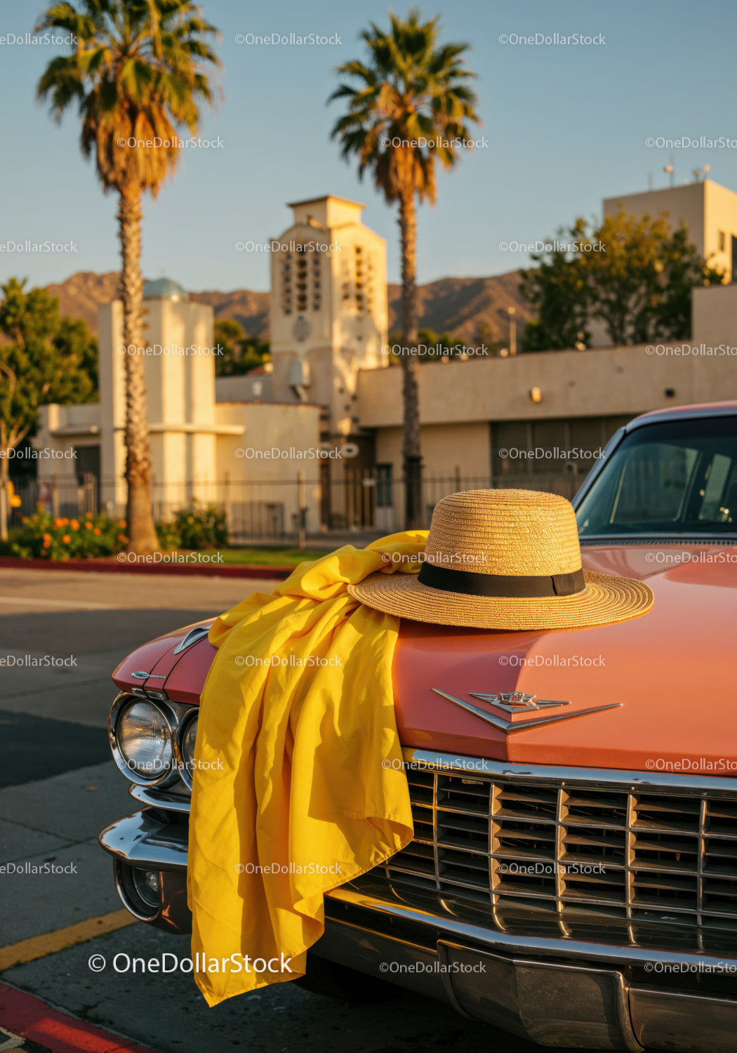 Vintage Pink Classic Car with Straw Hat and Yellow Scarf in City Scene