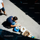 Man Preparing Street Food with Fresh Ingredients Outdoors