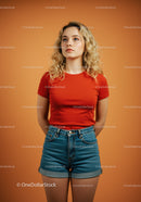 Young woman wearing red shirt posing on orange background