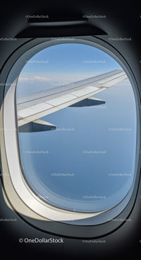 Airplane Wing and Sky View Through Aircraft Window in Flight