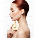 Elegant Woman with Red Hair Holding Pear in Wellness Portrait