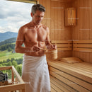 Man in Towel Relaxing in Outdoor Wooden Sauna With Mountain View