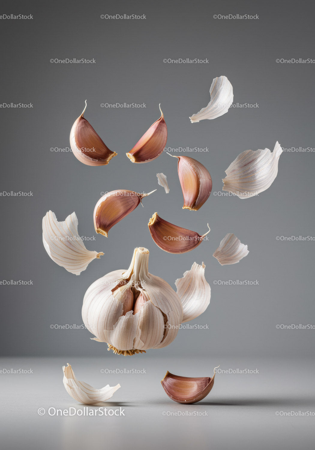 Floating garlic cloves and peeling skin in midair