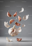 Floating garlic cloves and peeling skin in midair