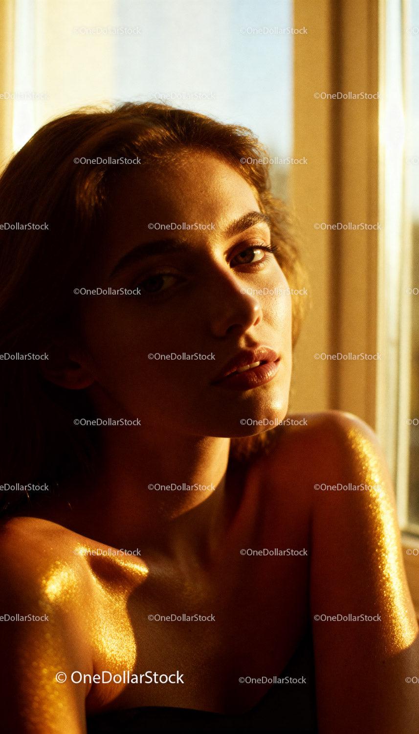 Golden light highlights young woman's radiant skin