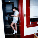 Young Woman Listening to Music with Classic Walkman