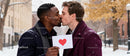 Romantic winter kiss between two men with heart card