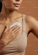 Close-up of Woman Applying Moisturizer to Chest for Healthy Skin