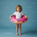 Little girl playing with inflatable donut float