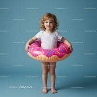 Little girl playing with inflatable donut float
