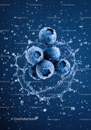 Fresh blueberries splashing into water droplets