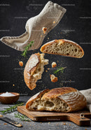 Freshly Baked Artisan Bread with Floating Crumbs and Herbs