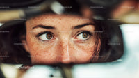 Close-up of Woman with Freckles and Brown Eyes Wearing Eyewear