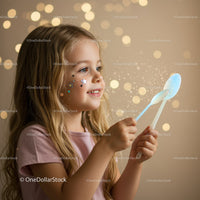 Little girl creating magical light with spoons