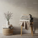 Neatly Folded Linen Towels in Minimalist Room Setting