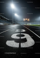 Empty Running Track at Night under Stadium Lights