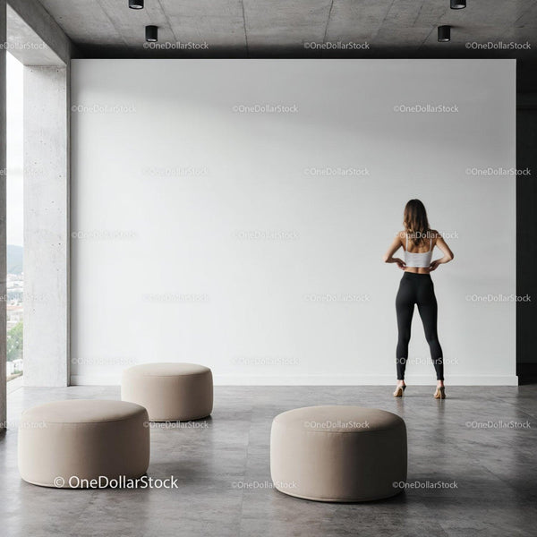 Woman standing in minimalist modern space with ottomans JPG Mockup Image