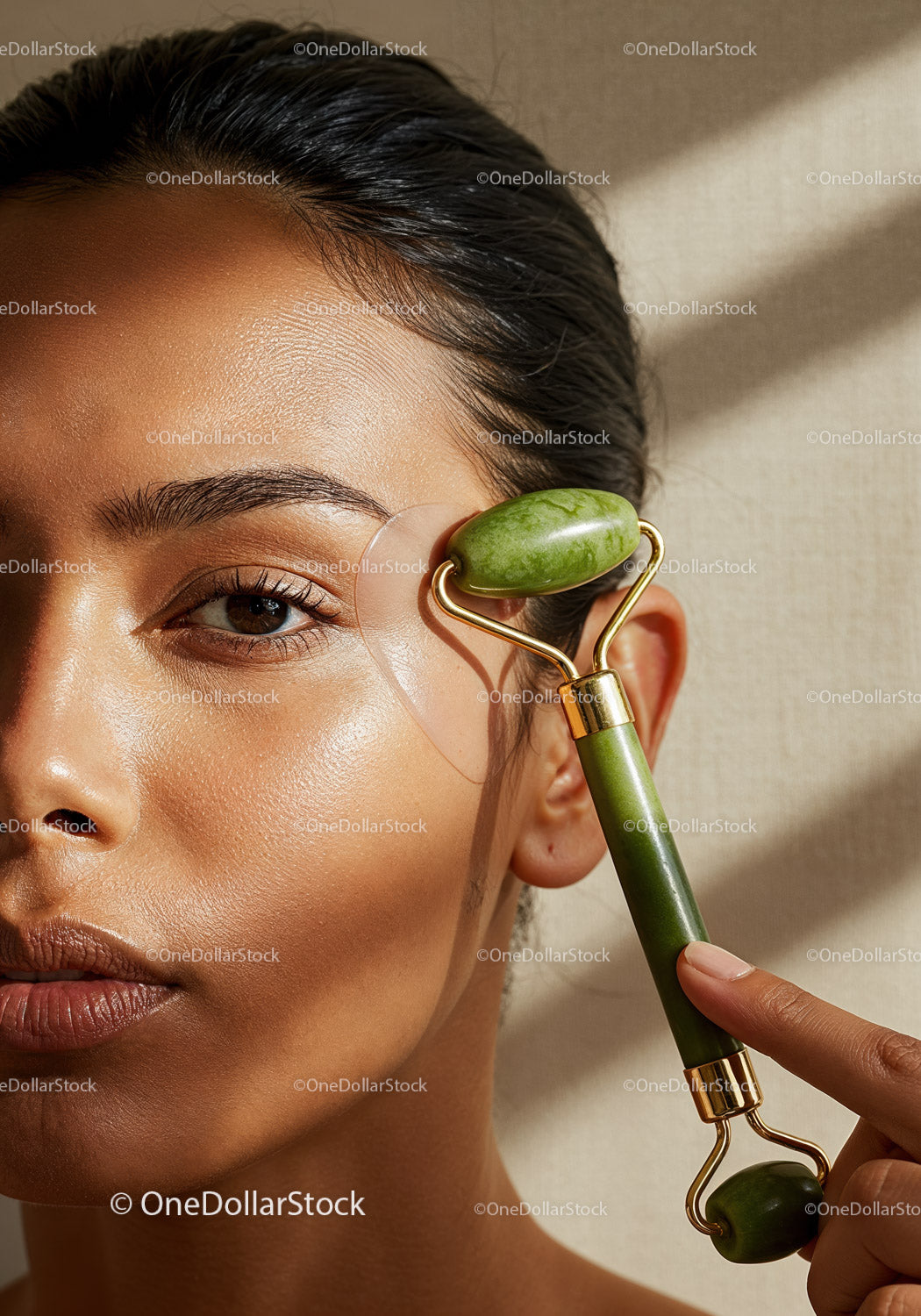 Close-Up of Woman Using Jade Roller for Facial Massage and Skincare