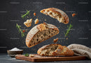Rustic sourdough bread with flying crumbs and rosemary