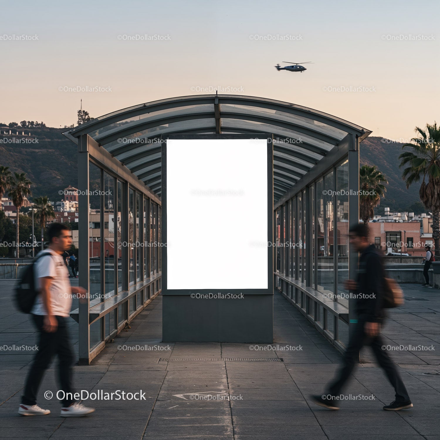 Urban walkway with blank advertising board at dusk