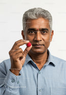 Senior Man with Gray Hair Holding Raspberry Against Plain Background