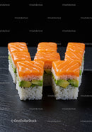 Fresh salmon avocado sushi cubes on black slate