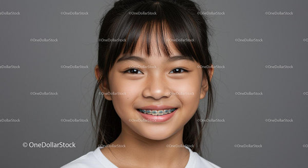 Smiling Girl with Braces Portrait in Gray Background