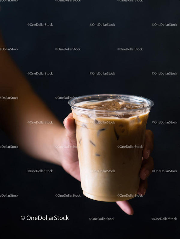 Iced Coffee with Milk in Glass Cup Handheld Cool Beverage Scene