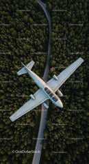 Small Jet Flying Over Dense Forest on Clear Day