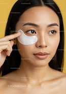 Young Asian Woman Applying Under Eye Patches for Skincare Routine