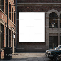 Blank billboard on urban brick wall with vintage cars