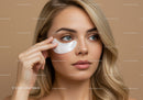 Close-Up Portrait of Beautiful Blonde Woman Applying Facial Mask