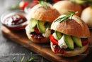 Gourmet Mini Sandwiches with Fresh Vegetables and Herb Garnish