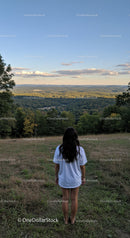 Woman Enjoying Serene Mountain View at Sunset