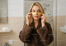 Young Woman with Gold Under Eye Patches Preparing for Skincare Routine