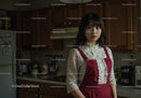 Young Woman in Red Apron in Modern Kitchen Indoor Scene