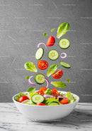 Fresh vegetables tossed in white bowl with flying slices