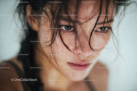 Close-up of Wet-Haired Woman with Intense Expression and Water Droplets
