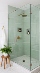 Modern bathroom shower with glass enclosure and green tiles