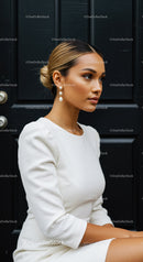 Elegant woman with sleek hairstyle in white dress